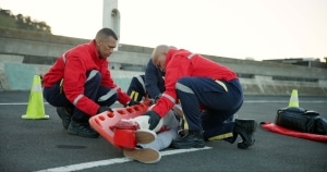 EMS team transporting a car crash victim on the road